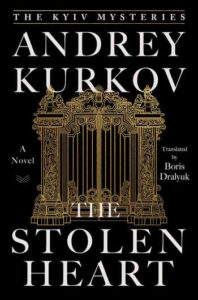 Cover of The Stolen Heart shows an elaborate gilded gate against a black background.