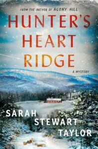 Cover of Hunter's Heart Ridge is a painting showing a rustic building in a snowy clearing surrounded by woods with mountains in the background.