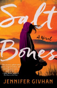 The cover of Salt Bones shows a figure with dark hair wrapped in a purple cloak beside a body of water reflecting an orange sky.