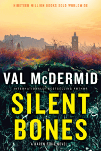 Cover of Silent Bones shows disturbed earth in the foreground and a view of Edinburgh Castle and a clock tower in the background against a hazy yellow sky.