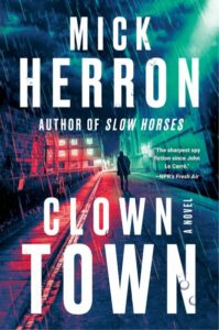 The cover of Clown Town shows a man walking down a neon-lit city street.