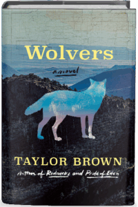 The cover of Wolvers shows the outline of a wolf superimposed over a range of rugged mountains.