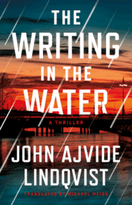 Cover of The Writing in the Water shows a bridge over water at sunset. 