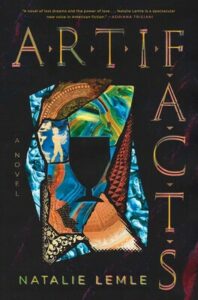Cover of Artifacts shows a chalice against a stained glass window made of fragments.