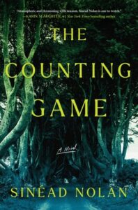 Cover of The Counting Game has the photo of an overgrown and tangled set of trees with a path running toward them, all in dark grays and greens. 